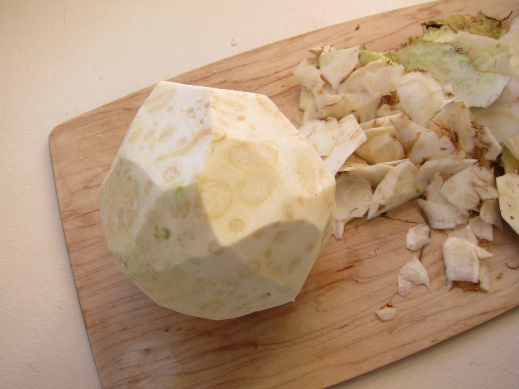 Slice the skin off the celery root, and then cut into bite-sized pieces.