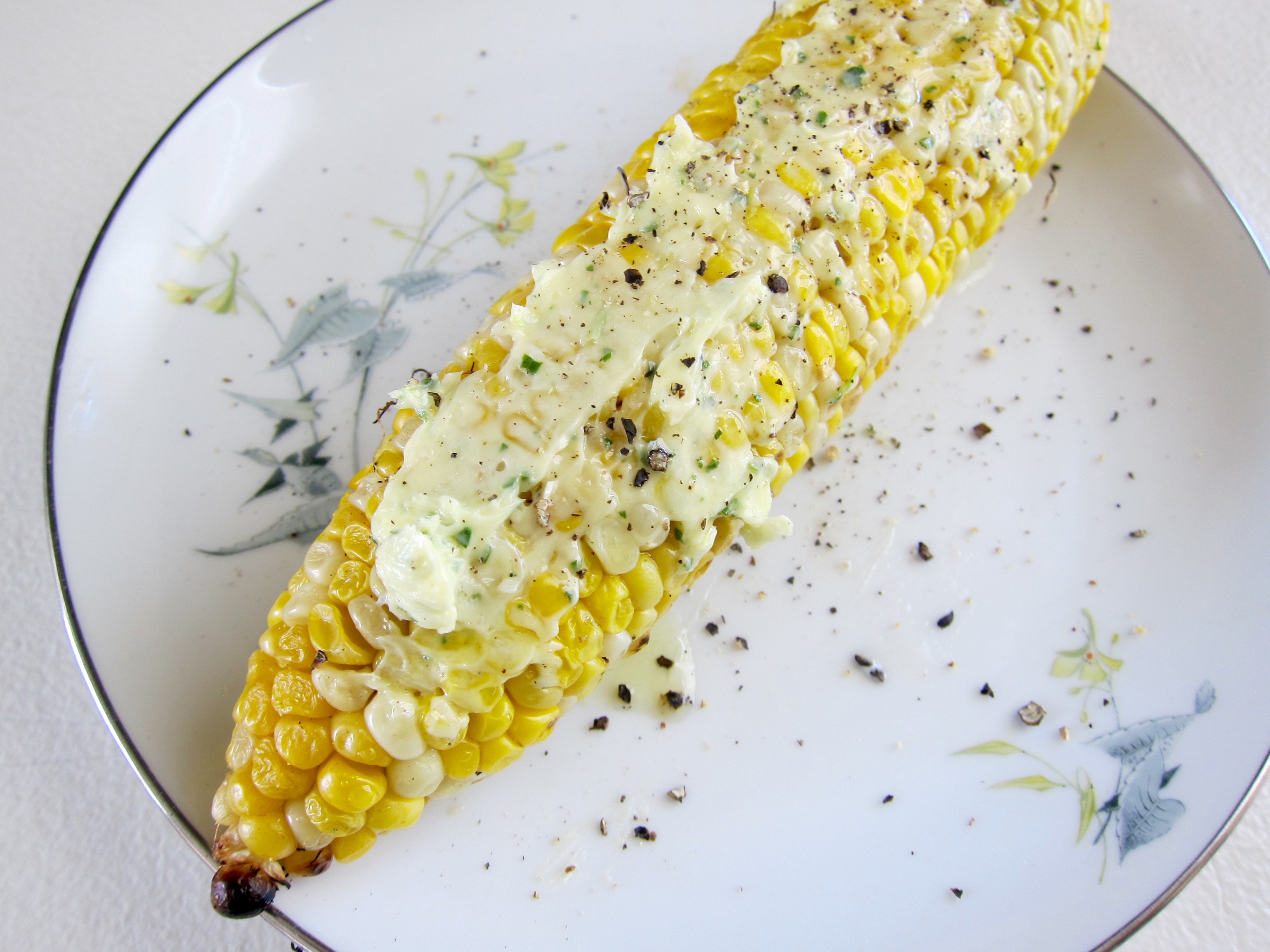 Herbed butter with fresh oregano and garlic tastes delicious on grilled corn.