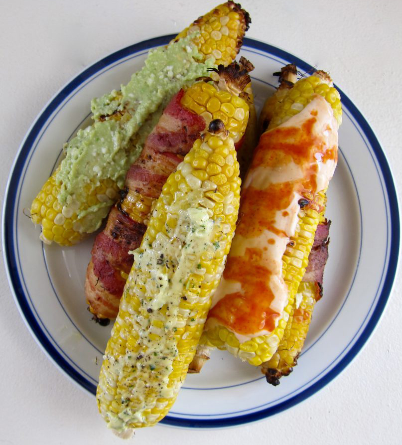 Grilled corn on the cob, served with multiple toppings, is a seasonal treat that can't be beat! 