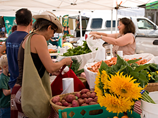 Shoppers buying fresh produce at an outdoor market in New Mexico